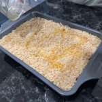 Golden crispy Rice Krispie topping on a baked chicken and rice casserole recipe in a pan