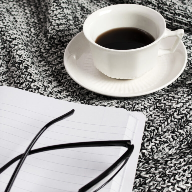 flat lay with coffee and yarn representing simple frugal living habits