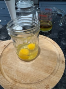 Eggs added to mason jar homemade mayonnaise