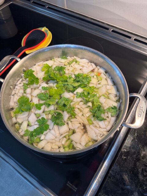 Easy homemade vegetable soup cooking in a stainless steel pot on the stovetop