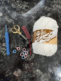 lily sugar'n cream cotton yam with crochet hook, stitch markers, and scissors for kitchen crochet projects