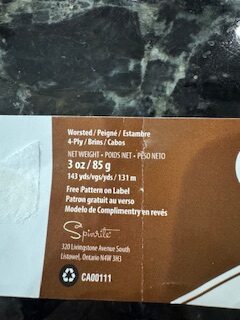 yarn label wrapper indicating the yardage and length in the skein