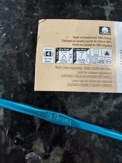 yarn label wrapper details indicating yarn and hook recommendations with the hook in image