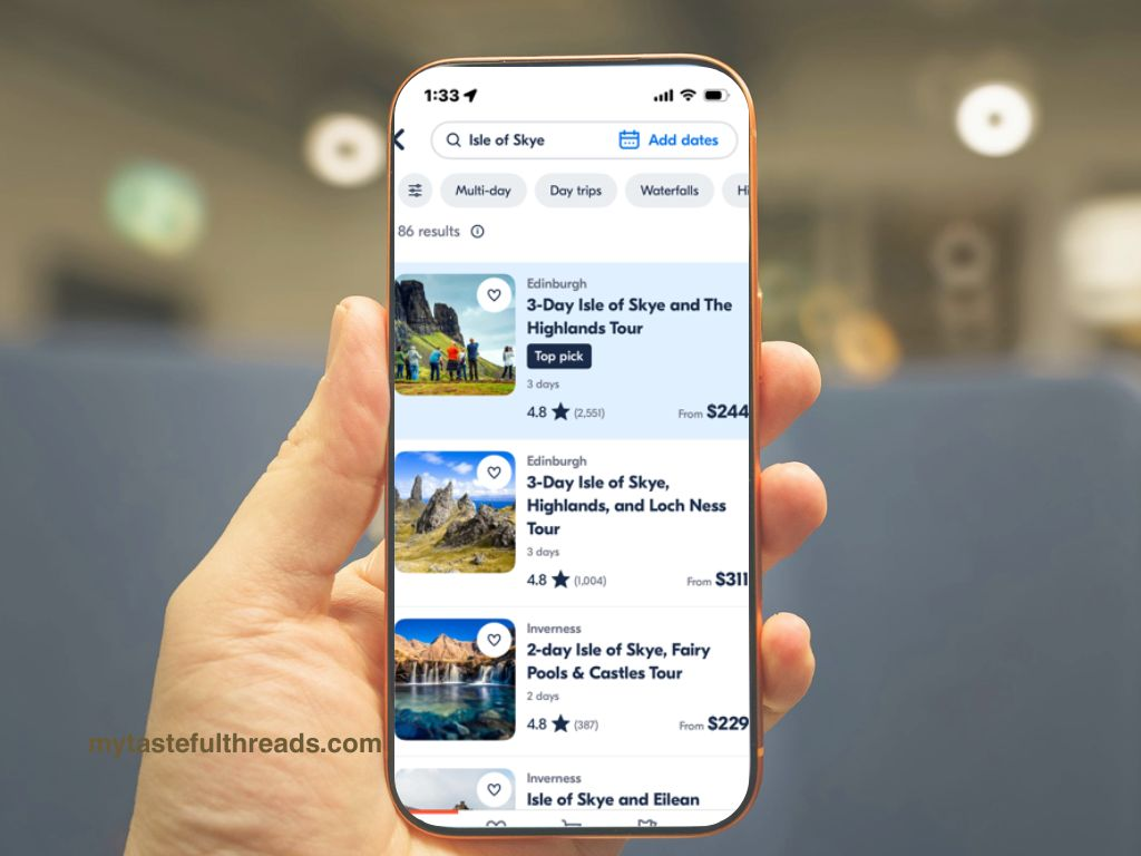 Hand holding a phone showing GetYourGuide app search results for Isle of Skye tours in Scotland