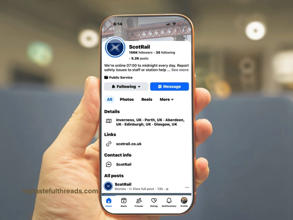 Hand holding a phone showing the ScotRail Facebook page with train service information for Scotland