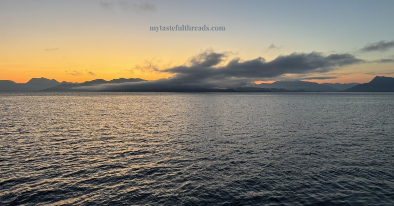 Sunrise over the water near Oban Scotland with golden light reflecting on the calm sea