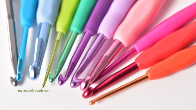 Rainbow-colored ergonomic crochet hooks with soft grip handles fanned out on a white background